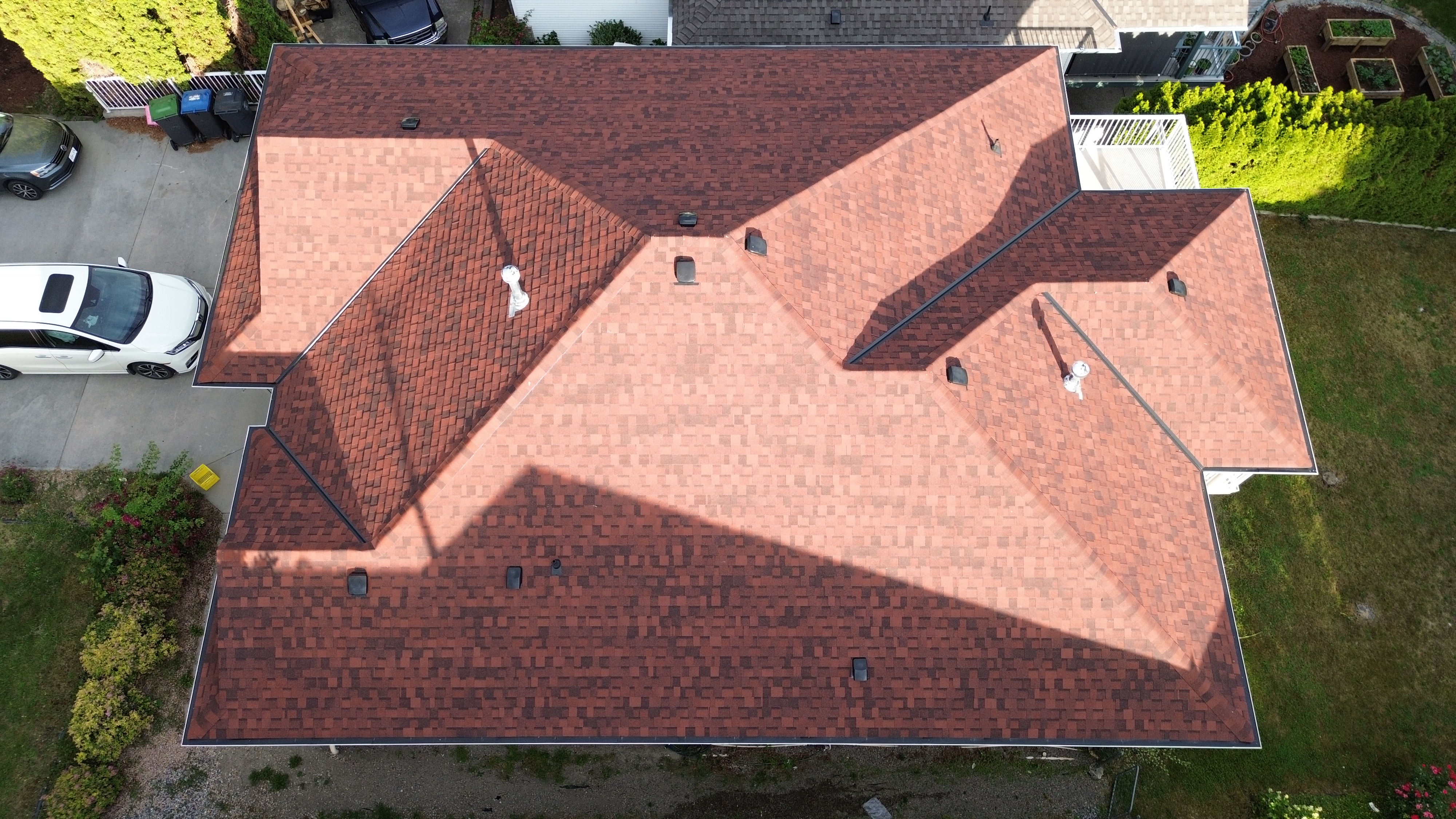 Aerial view of completed brown shingle roof